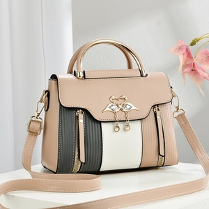 Vintage color block crossbody bag with elegant golden swan clasp on a white pedestal