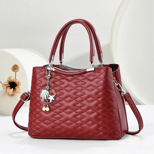 Deep red leather tote bag with quilted pattern, silver hardware and shell charm