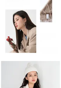Detail showing white ribbed knit beanie and minimalist silver hoop earrings set