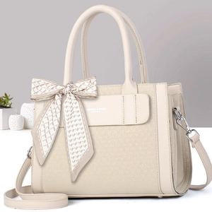 Beige faux leather tote bag with embossed texture and decorative silk scarf handle
