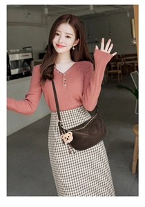 Detail of dark coffee crescent crossbody bag with cute teddy bear charm on casual outfit