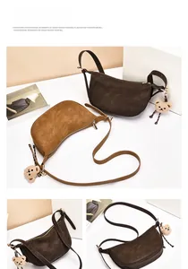 Detailed view of saddle shoulder bags in dark coffee and caramel suede with bear charms