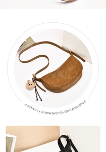 Detail of a brown leather crescent shoulder bag featuring a cute bear plush pendant