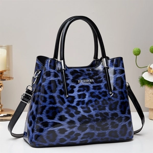 Blue leopard print patent leather tote bag with dual handles and adjustable shoulder strap