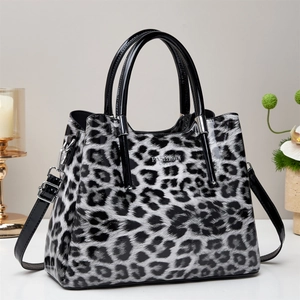 Close-up of glossy leopard print tote bag with silver Fashion logo and shiny leather texture