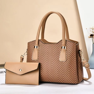 Close-up of brown textured large tote bag with matching envelope clutch and gold hardware