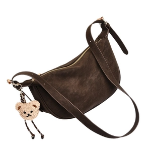 Classic dark brown crescent shoulder bag with fuzzy bear charm and gold zipper details