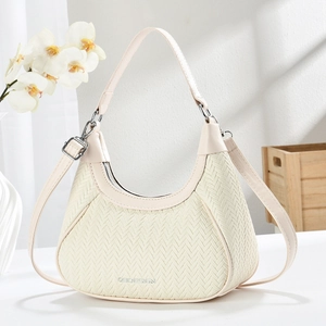 Elegant cream crescent hobo bag with V-weave texture and adjustable silver-tone strap
