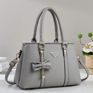 Sac à main élégant gris texture litchi avec pendentif nœud et détails dorés