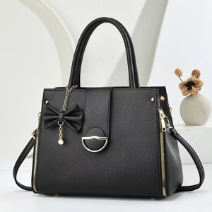 Minimalist black lychee texture tote bag with elegant bow and pearl pendant charm