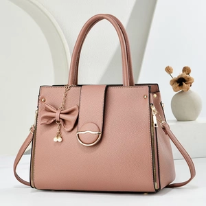 Elegant rose pink lychee leather tote bag with pearl bow charm and metal clasp detail