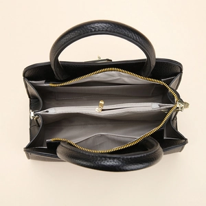 Internal view of black pebble leather tote with grey herringbone lining and compartments