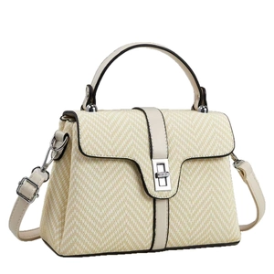 Beige woven crossbody bag with leather handles and silver twist lock on white background
