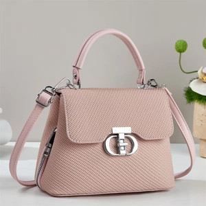 Elegant light pink crossbody bag with woven texture and CD logo on grey background