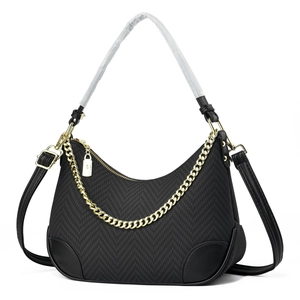 Black crescent chain shoulder bag with gold hardware and leather trim details