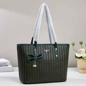 Deep green woven tote bag with bow detail and silver brand plate for women's fashion