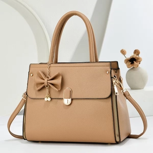 Minimalist large capacity crossbody bag in camel leather with bow and pearl pendant charm