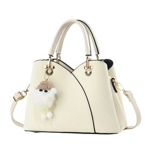 Elegant cream white faux leather tote bag with plush charm and adjustable strap