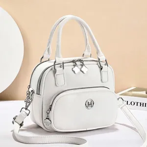 Chic white PU leather round handbag with M logo and adjustable strap for women