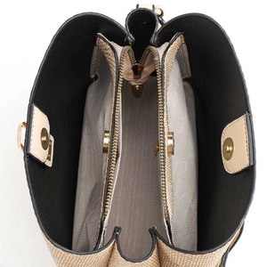 Interior view of women's tote showing three compartments and gold zipper pocket