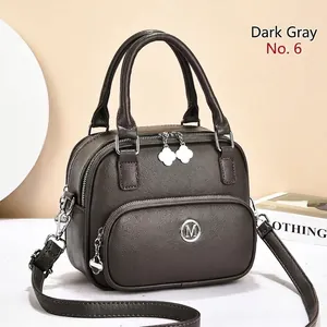 Detailed macro view of dark grey litchi grain PU leather handbag with clover charm