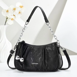 Detail of black pleated cloud bag featuring silver metal chain and fashion text print