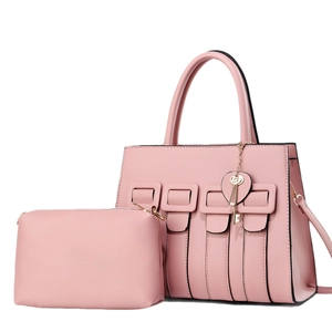 Pink faux leather handbag set with shoulder strap and decorative heart keychain charm