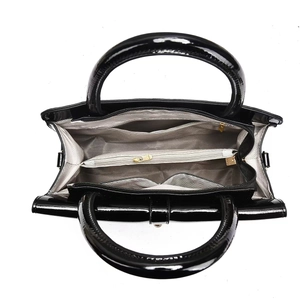 Interior view of large patent leather handbag featuring herringbone lining and compartments