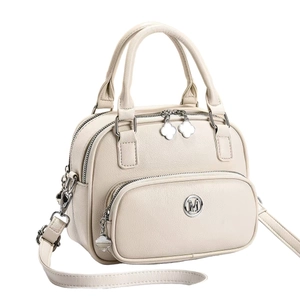 Chic beige PU leather Boston handbag for women with metallic M logo and clover charm