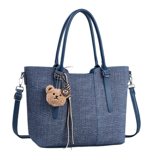 Classic blue denim tote bag with plush bear charm and adjustable shoulder strap