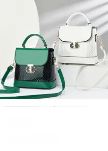 Detail of glossy patent leather crossbody bags with GD buckle and checkered pattern