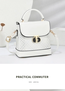 Detail of white crossbody bag with grey plaid pattern and golden metal lock