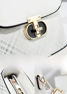 Detail of white checkered crossbody bag featuring premium light gold T-shaped rotary lock