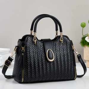Elegant black woven bucket bag for women with gold hardware and a detachable strap