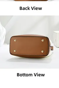 Detail view of the brown leather bottom and golden metal feet of a bucket handbag