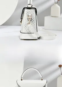 Detail view of white plaid handbag with gold hardware and side profile profile shape