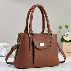 Brown lychee leather handbag with silver hardware and adjustable strap for elegant women