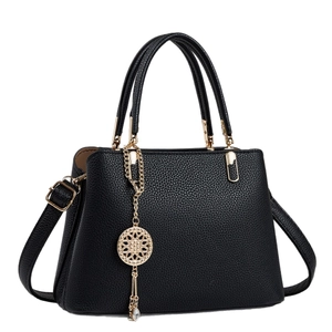 Classic black litchi grain tote bag with gold hardware and geometric tassel charm