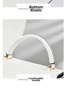 Detail showing white patent leather handle with gold hardware and protective base studs