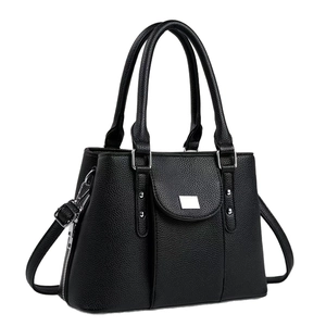 Chic black litchi textured handbag with silver hardware and shoulder strap, 45-degree view