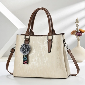 Beige textured Boston handbag with brown leather straps and colorful LOVE charm