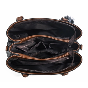 Detailed interior of a spacious three-layer handbag featuring brown fabric lining and dividers