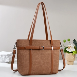 Brown woven bucket bag with leather handles and adjustable strap for women in 2025
