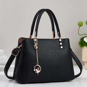 Fashionable black pebbled leather tote bag with gold hardware and removable shoulder strap
