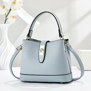 Light blue bucket bag with woven texture, round handle, and gold metal lock detail