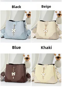 Close-up of stylish herringbone fabric bucket bags with metallic bow charm in four colors