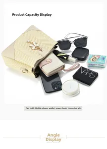 Detail view of large capacity straw bucket bag showing phone and cosmetics storage