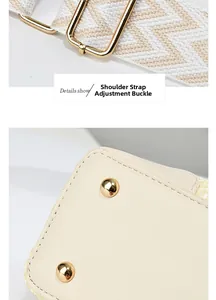 Detail of cream bag showing adjustable woven strap and bottom gold metal studs