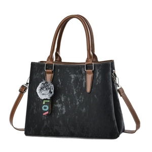 Retro black textured tote bag with brown handles and a grey pompom keychain charm