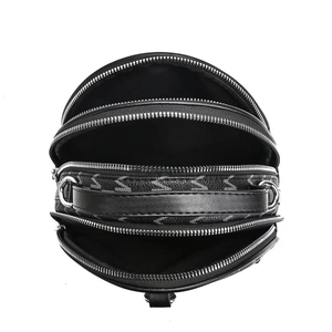 Top view of large capacity black leather crossbody bag with three zipper compartments